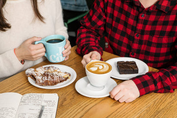 couple drinking coffee, eating baked goods