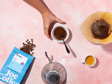 hand grabbing ground coffee