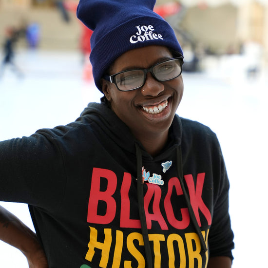 Joe Coffee employee modeling the logo beanie