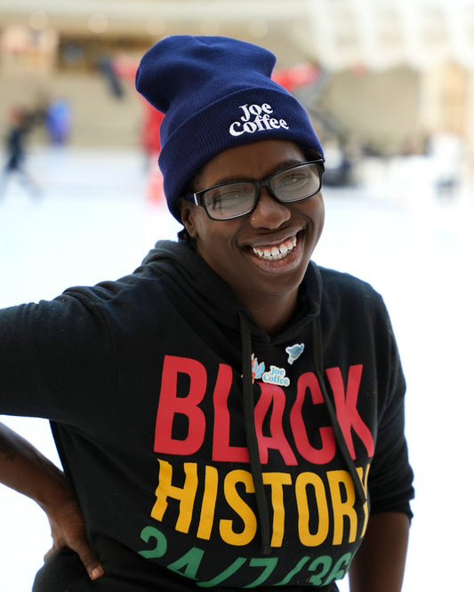 Joe Coffee employee modeling the logo beanie