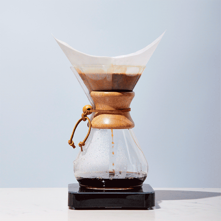 Coffee extracts in a Chemex and is served in two cups