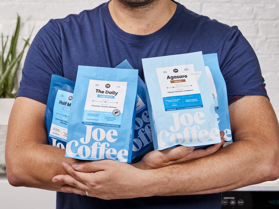 Man holding bags of coffee